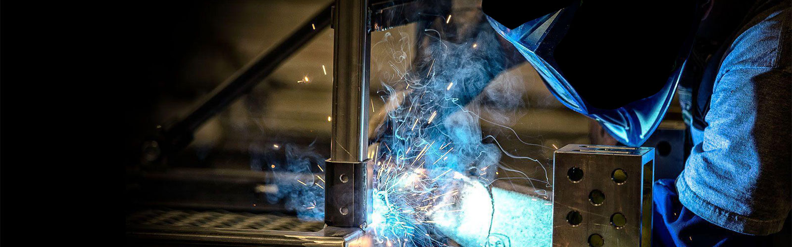 Man Welding with Orpex Modular Welding Table