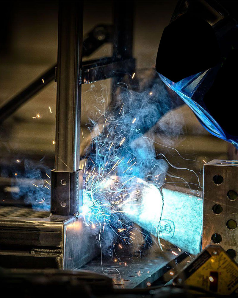 Man Welding with Orpex Modular Welding Table